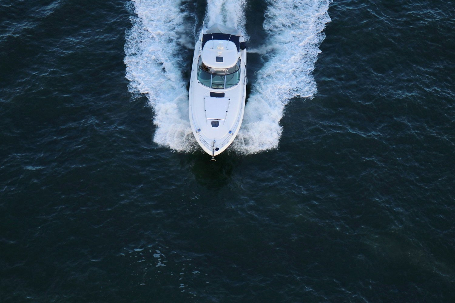 Boat at night on the water, representing marine security and monitoring
